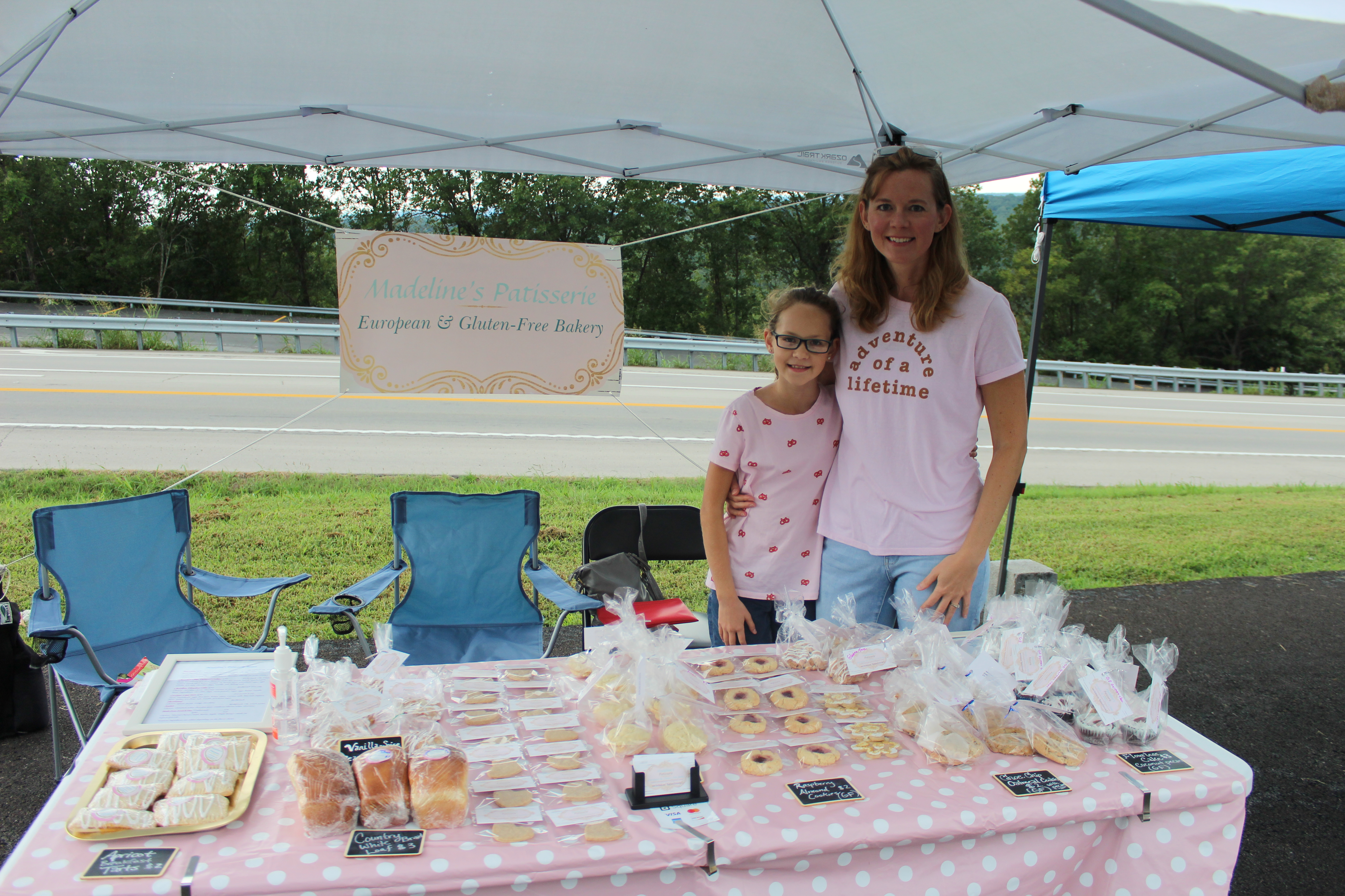 190817 1time Madeline Hanley left and Kristen Hanley right pose at their table where they are selling baked goods for Madeline Patisseries. - New Farmer’s Market, train system, eateries, and live shows at Shepherd of the Hills